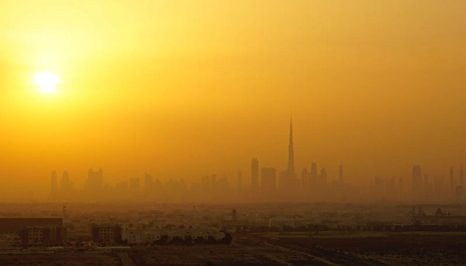 Dubai skyline at dusk with the call to prayer hour approaching.
