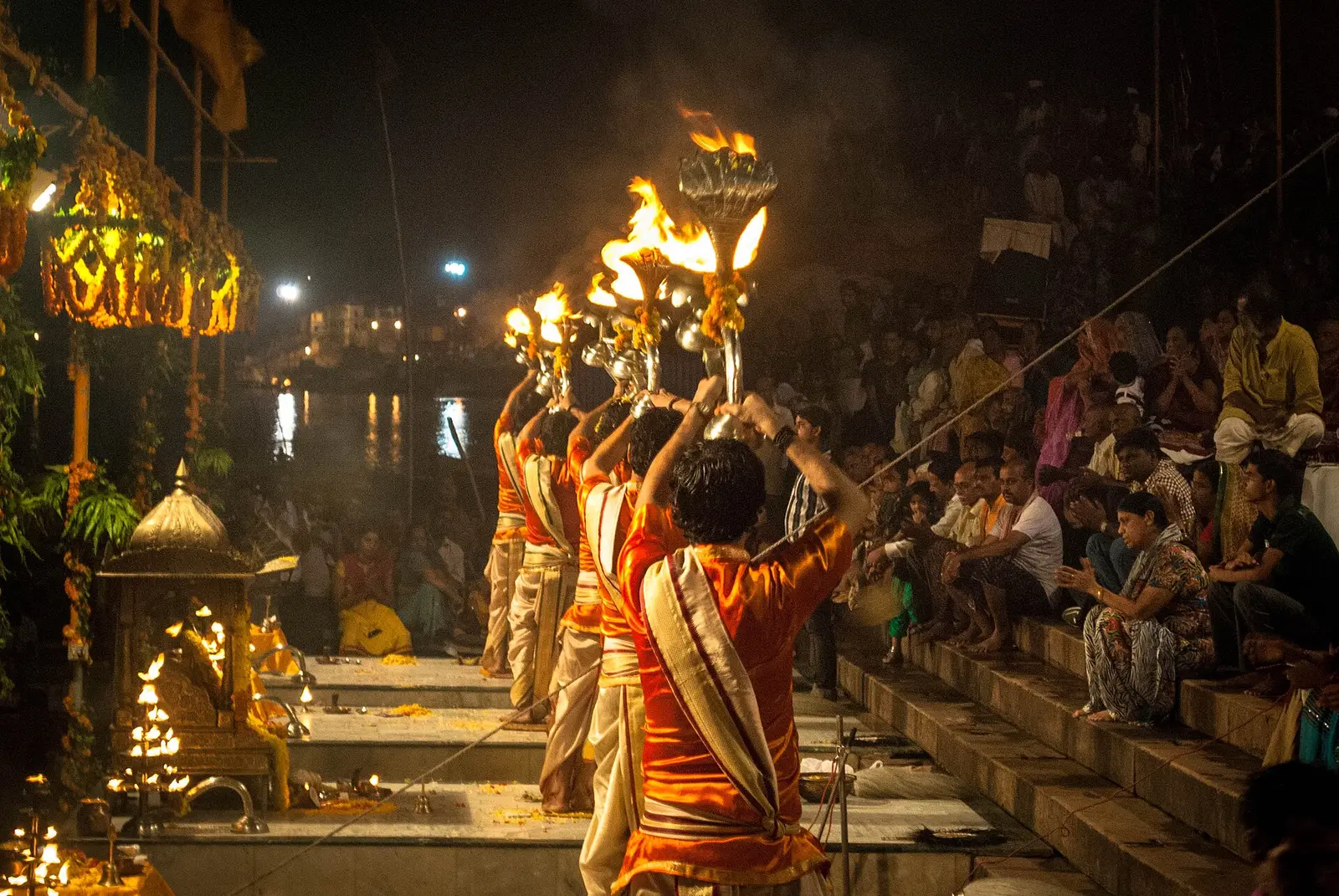 Priests performing Ganga Aarti with brass lamps at Dashashwamedh Ghat, Varanasi.