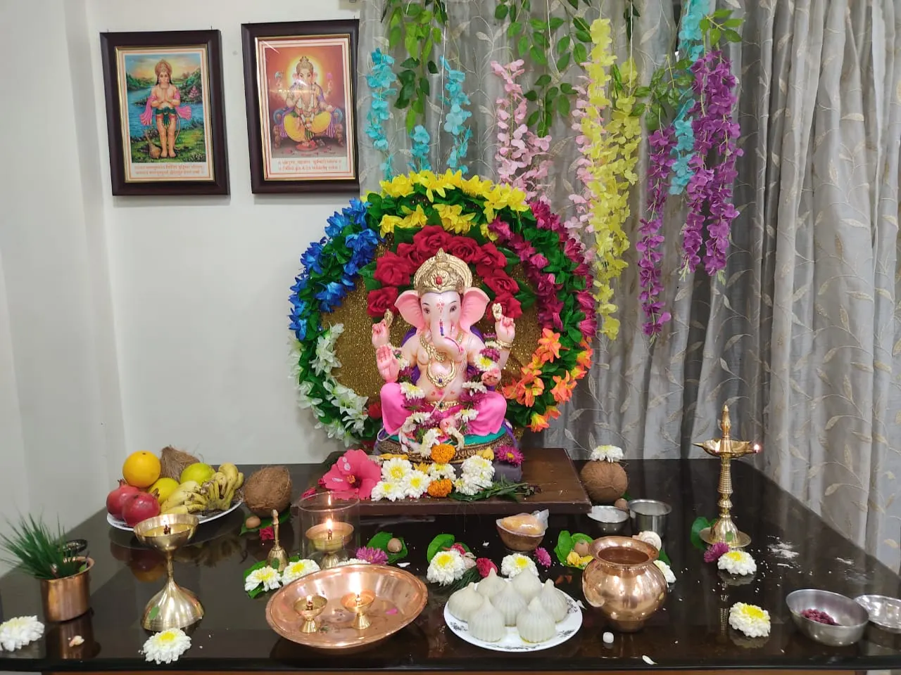 A decorated Ganesh idol on a home altar during festival season.