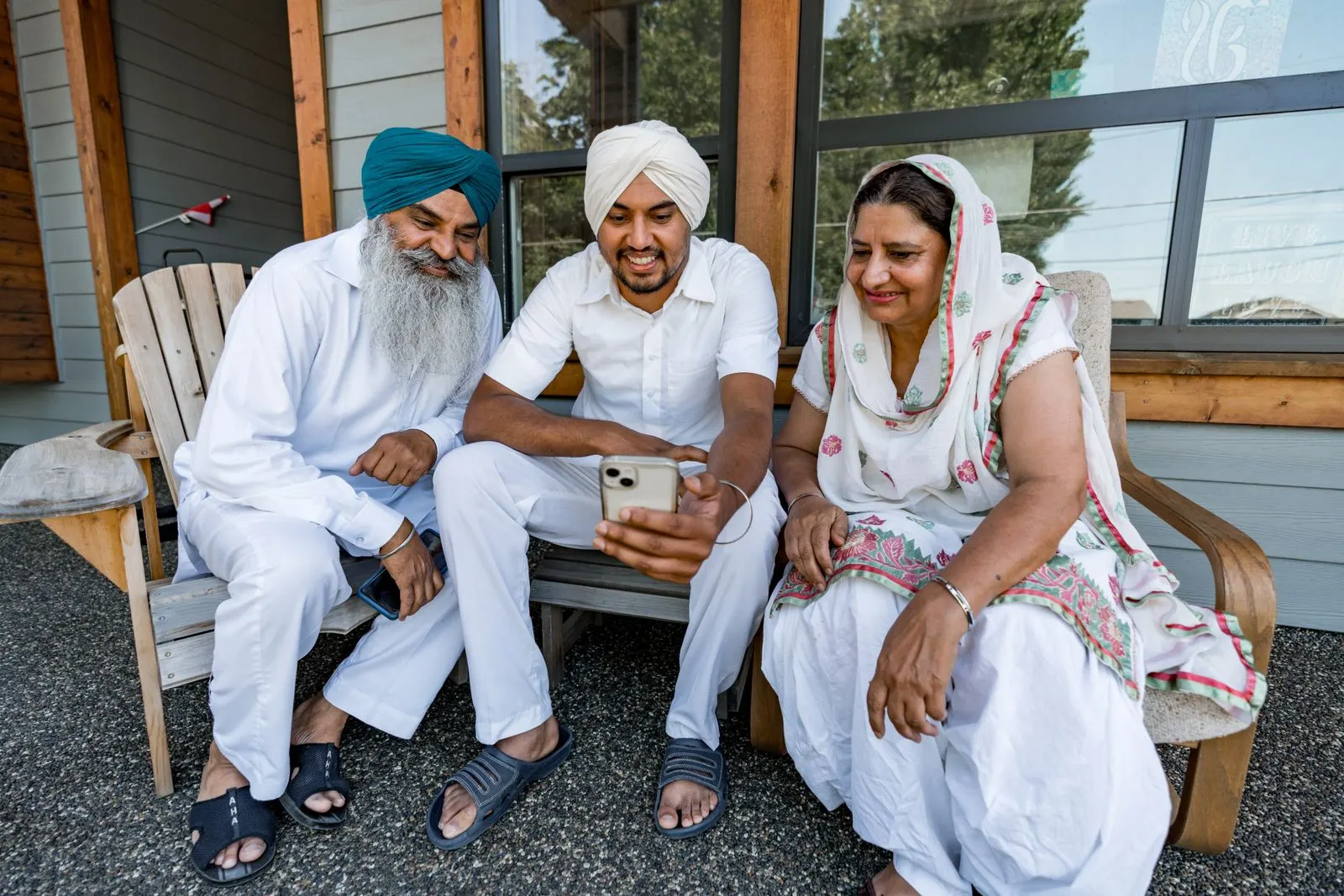 An elderly Indian couple speaking on the phone at home.