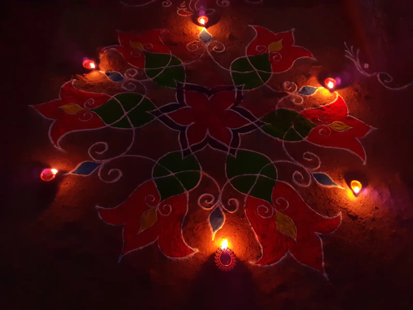 Diyas and rangoli decorating the entrance of a home during Diwali celebrations in the UK.