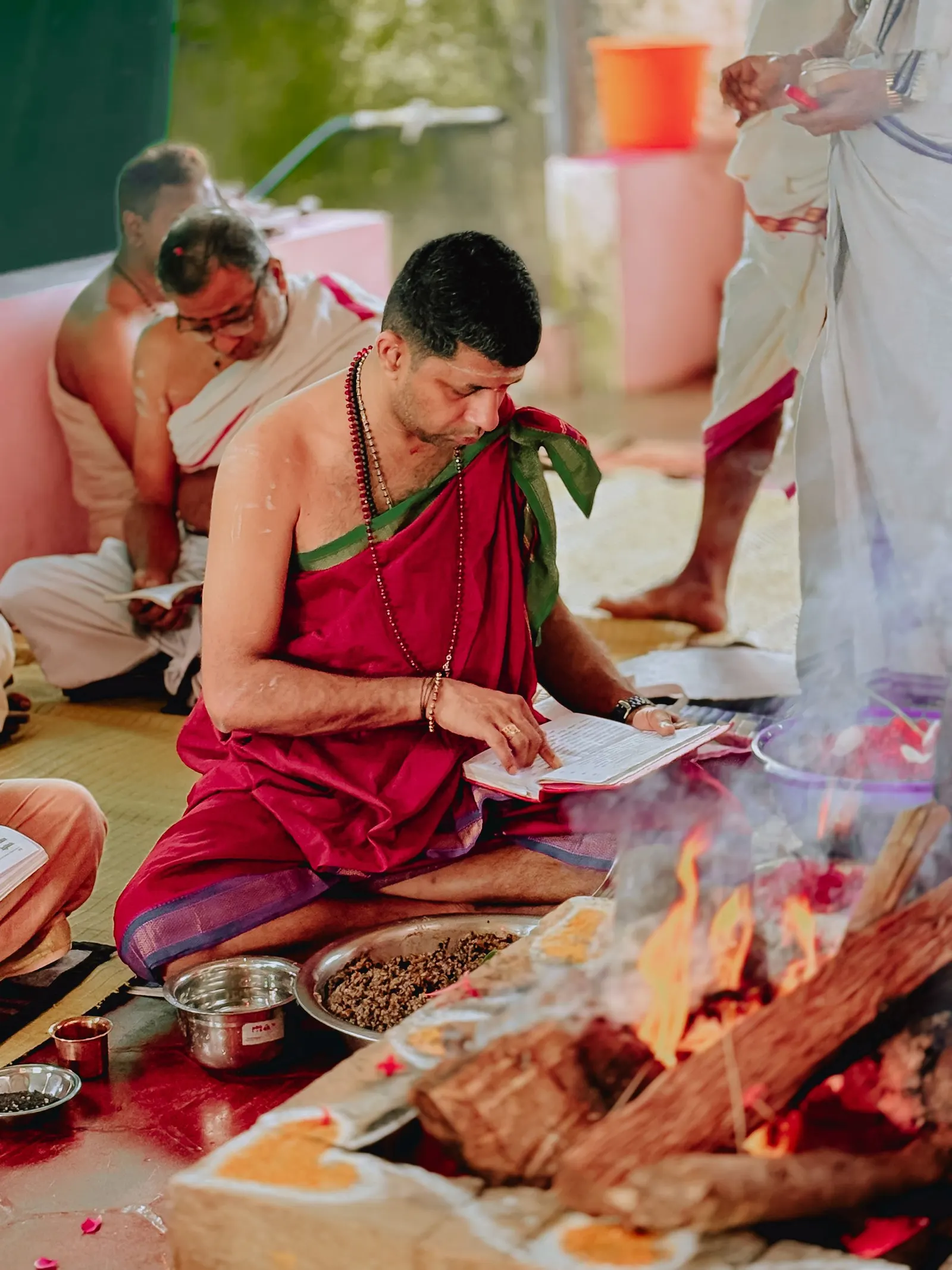 A pandit performing a fire ritual during a Vedic puja.