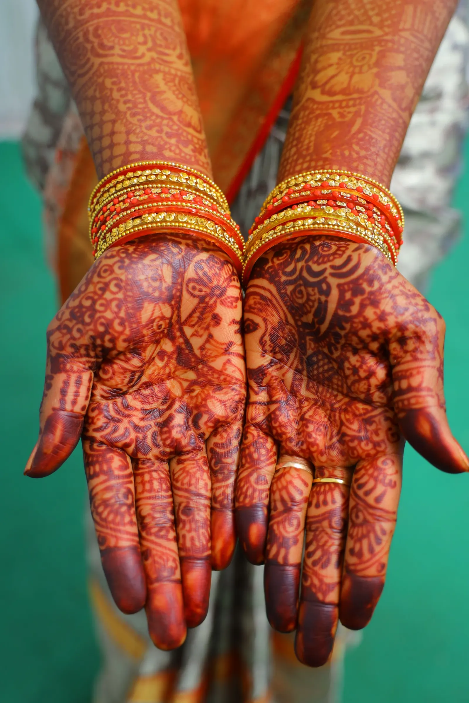Close-up of hands with mehendi before an Indian wedding.