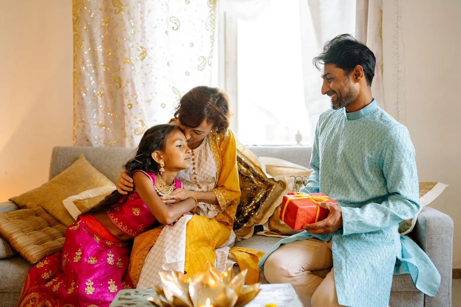 An Indian family celebrating a milestone together at home.