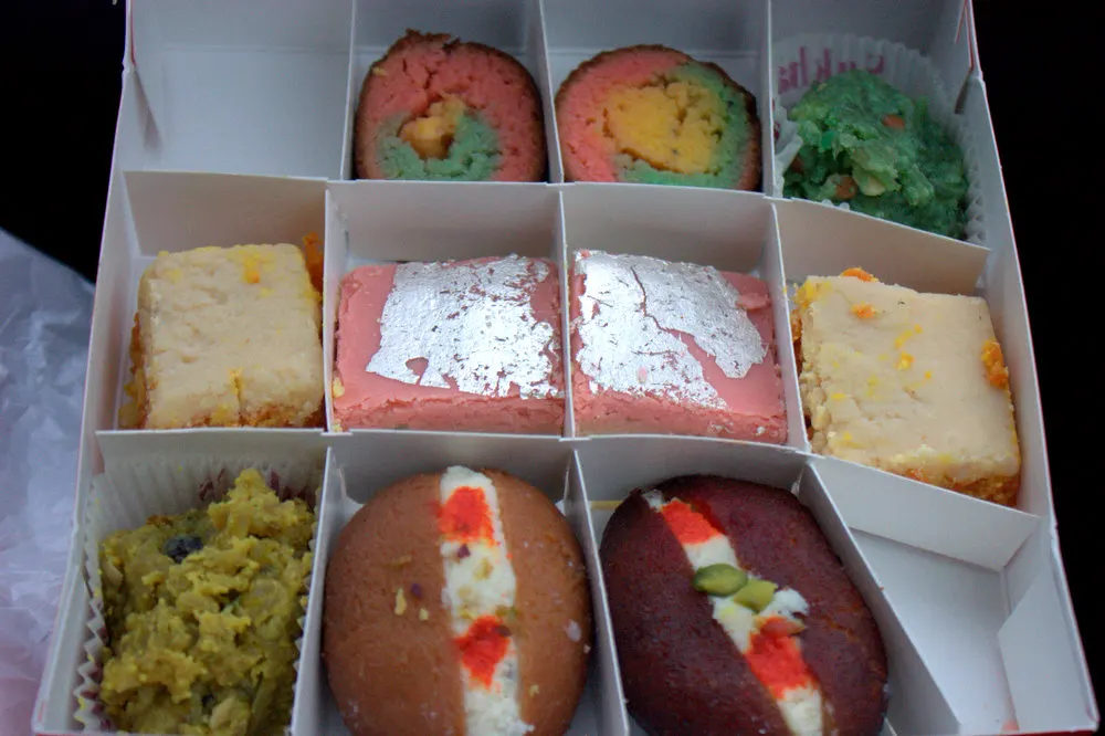 A family opening a prasad box shipped for Diwali celebrations abroad.