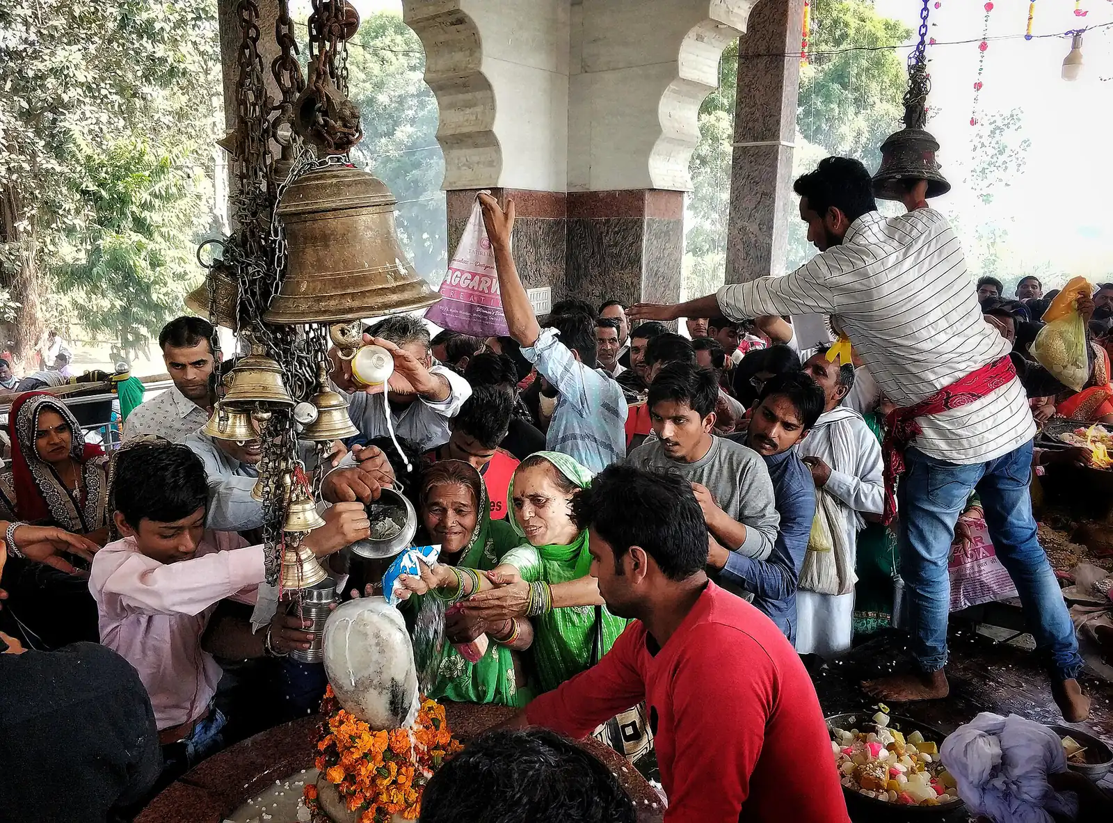 Milk being poured over a Shiva lingam during an abhishek ritual.