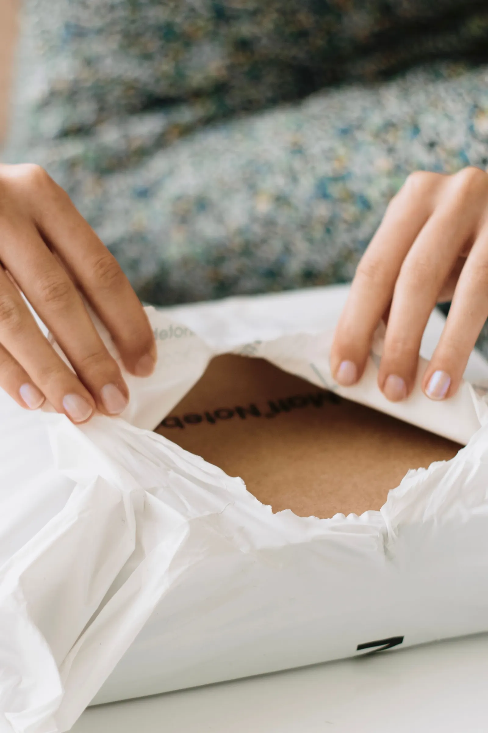A person unboxing a small package delivered to their doorstep.