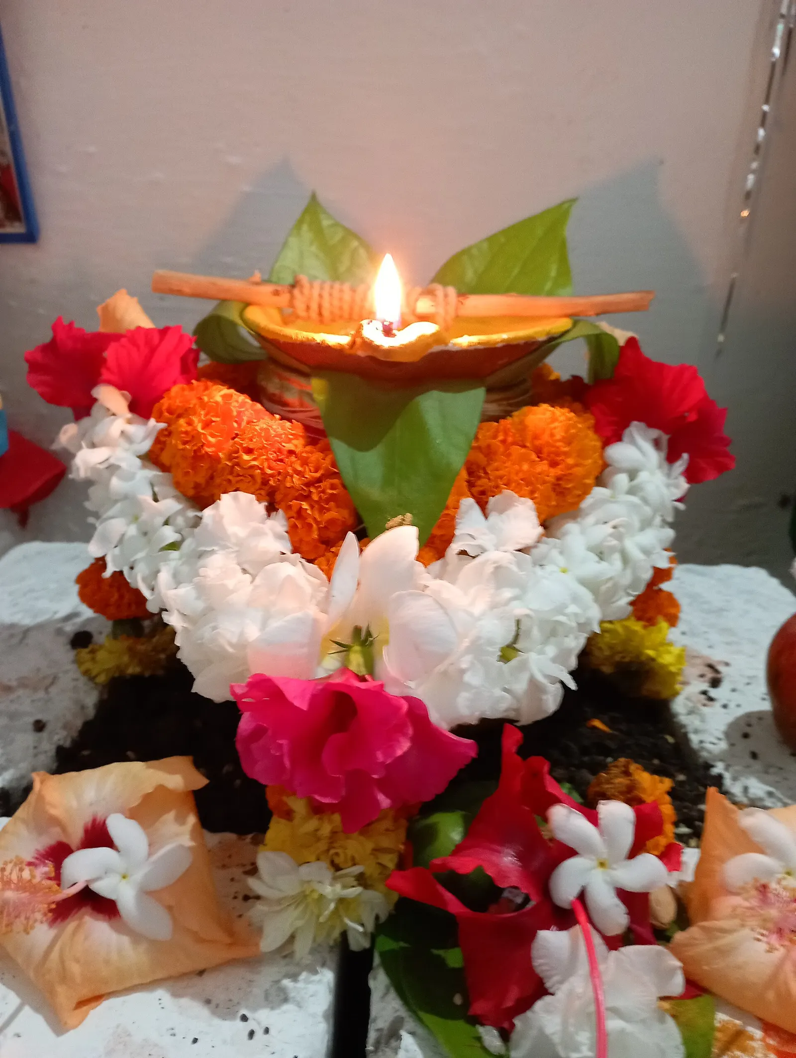 A traditional Kalash decorated with mango leaves and a coconut for Ghatasthapana.